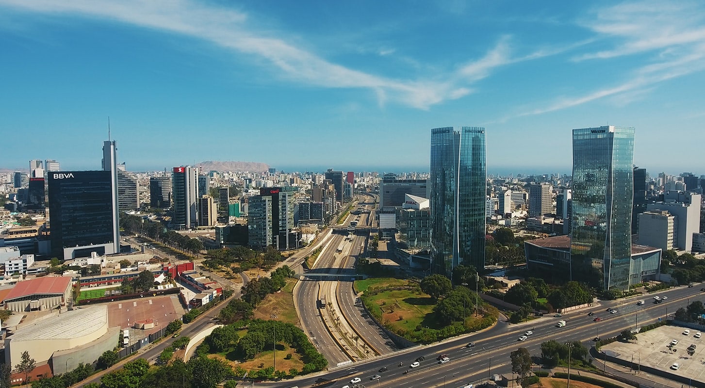 Aerial view of cityscape, illustrating the city's infrastructure and natural surroundings in a dynamic urban environment.